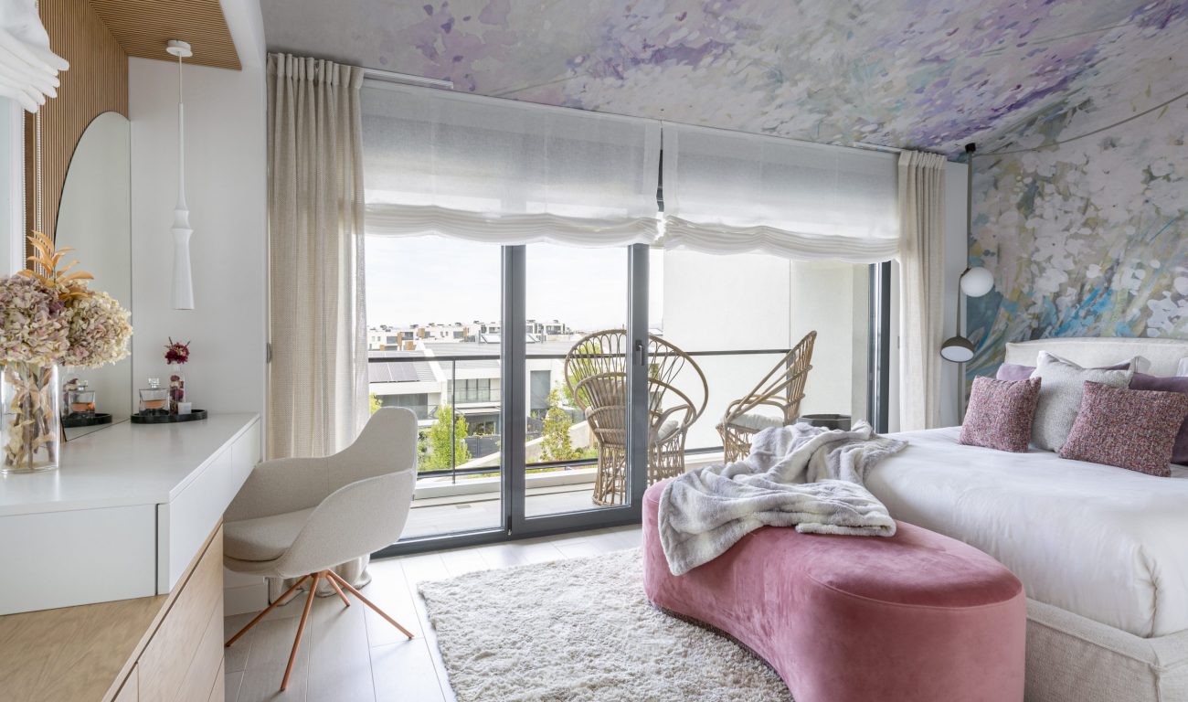 Dormitorio de matrimonio con colores suaves y un precioso papel pintado en techo.